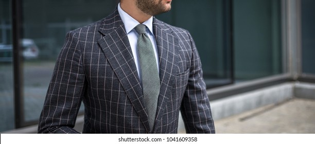 Man in custom tailored business suit posing outdoors
