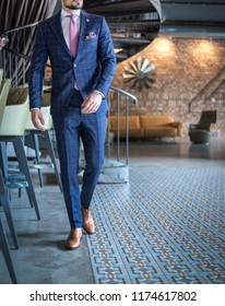 Man in custom tailored expensive business suit posing in bar