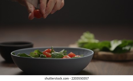 Man Cut Cherry Tomatoes Into Blue Bowl, Wide Photo