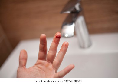 The man cut his finger. A cut. Blood flows from the finger