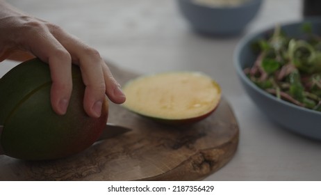 Man Cut Mango For Salad With Micro Greens And Mozzarella In Blue Bowl, Wide Photo