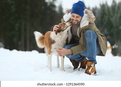 Man With Cute Dog Near Forest. Winter Vacation