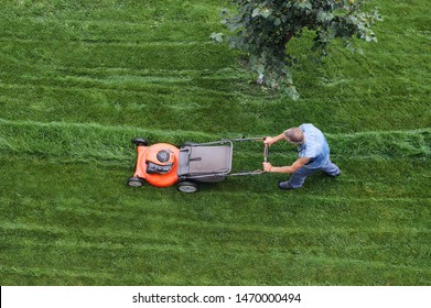 Man Cuts The Lawn. Lawn Mowing. Aerial View Lawn Mower On Green Grass. Lawn Mower Mower. Mowing Tool