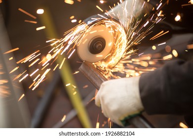 A man cuts metal using an angle grinder close-up. Many sparks - Powered by Shutterstock