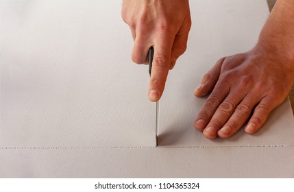 Man Cuts A Sheet Of Heat Insulating And Sound Proof Material With A Stationery Knife