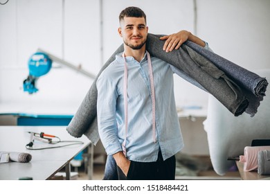 Man Cutter At A Sewing Factory Holding Fabric