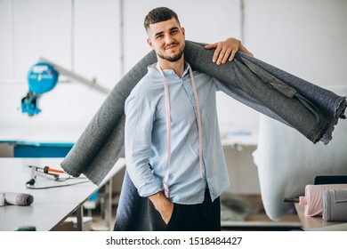 Man Cutter At A Sewing Factory Holding Fabric