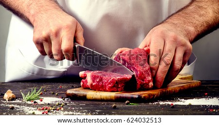 Man cutting beef meat.