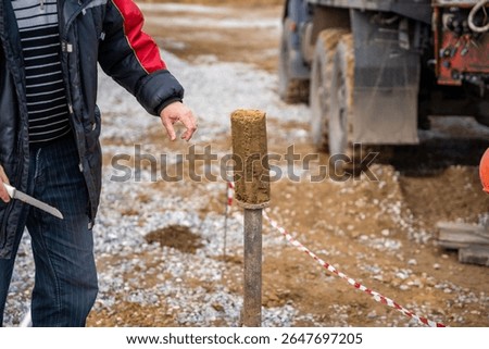Man cutting and cleaning soil sample for laboratory analysis. Preparation of core material for geotechnical testing and scientific evaluatio. High quality photo