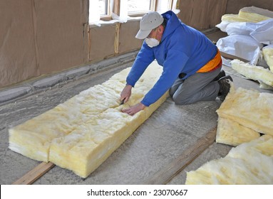 Man cutting fiberglass insulation