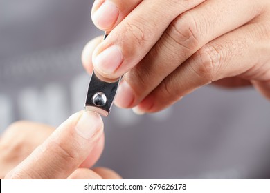 Man cutting nails - Shutterstock ID 679626178