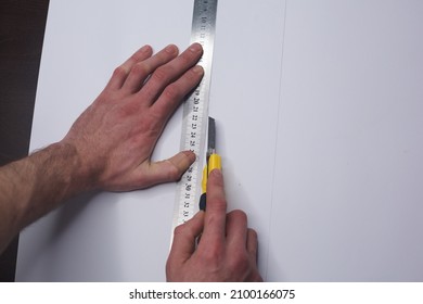 Man Cutting Paper With Exacto Knife