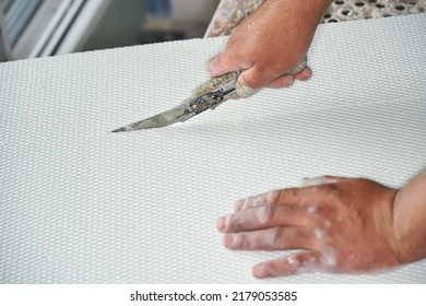 Man Cutting Polystyrene Foam Heat Insulation With Old Retractable Utility Knife, Closeup Detail