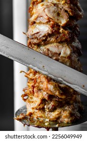 Man cutting prepared meat for Shawarma - Shutterstock ID 2256049949