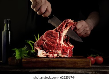 Man Cutting Raw Beef Meat.