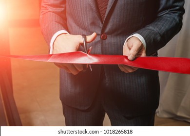 A man cutting a red ribbon, opening ceremony, isolated on white background