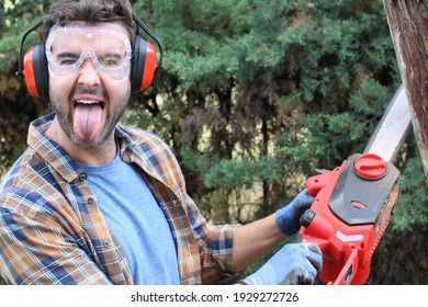 Man Cutting Tress With Chainsaw