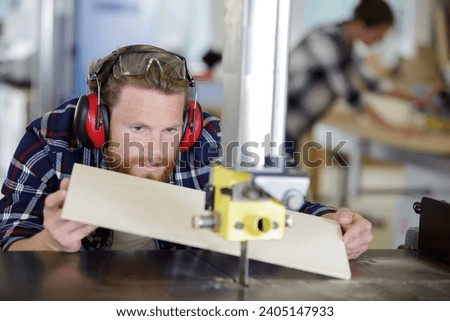 man cutting wood with a milling machine