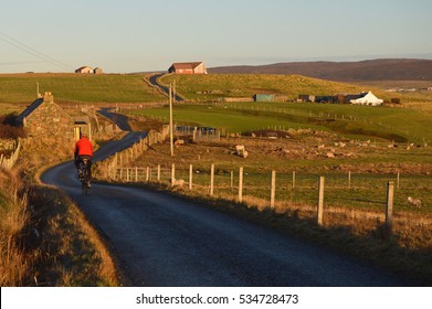 Man cycle touring on the road of Shetland Islands