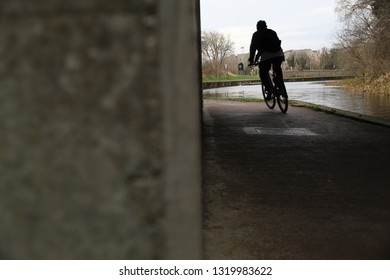 Man Cycling Along The Union Canal In Edinburgh