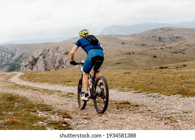 Man Cyclist Biking On Mountain Path On Mountain Bike