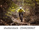 Man cyclist riding a mountain bike on a nature trail. Living a healthy lifestyle. 