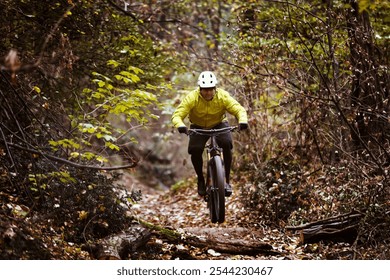 Man cyclist riding a mountain bike on a nature trail. Living a healthy lifestyle.  - Powered by Shutterstock