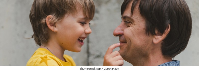 Man Dad Having Quality Time With Their Kid Son Boy Six Year Old On Arms. Happy Father Playing Together With Child. Real Life Authentic Day-to-day Fatherhood Moments. Fatherly Love Care. Banner