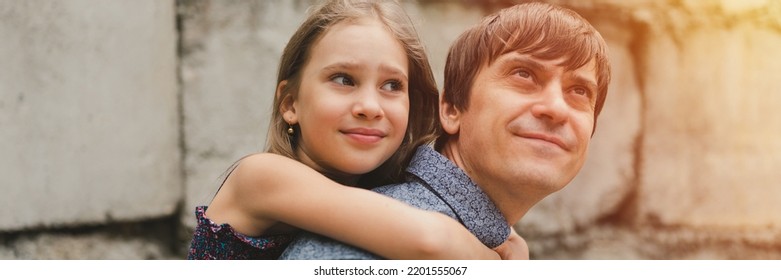 Man Dad Having Quality Time With Their Kid Daughter Girl Nine Year Old On His Back. Happy Father Playing Child. Real Life Authentic Day-to-day Fatherhood Moments. Fatherly Love Care. Banner. Flare