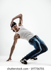 Man dancer showing break-dancing moves isolated on white 