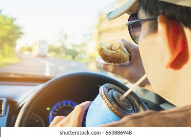 Man Is Dangerously Eating Hot Dog And Cold Drink While Driving A Car