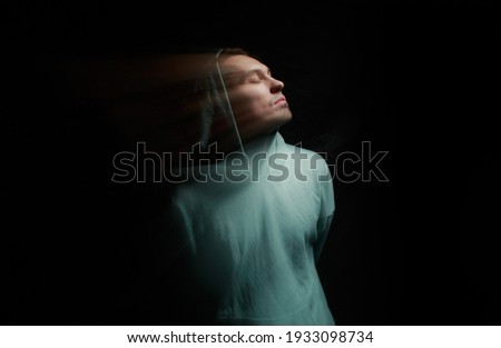 A man in the dark. Blurred portrait in motion.