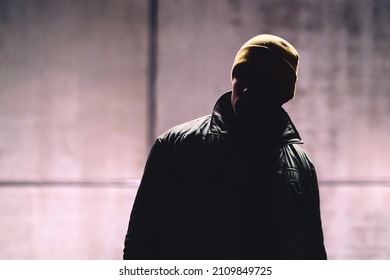 Man with dark face. Unknown stranger, stalker, thief or gangster in shadow. Secret hidden identity of mysterious person. Dangerous criminal in jacket. Handsome anonymous male fashion model in portrait - Shutterstock ID 2109849725