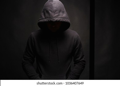 Man in dark, figure in a hooded sweatshirt. Incognito Boy - Shutterstock ID 1036407649
