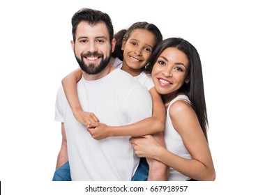 man and daughter piggybacking while woman standing near by isolated on white