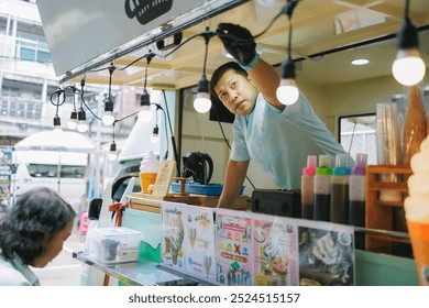 A man decorates his ice cream truck with lights at a vibrant outdoor market, preparing to serve customers and showcasing the colorful street food culture. - Powered by Shutterstock