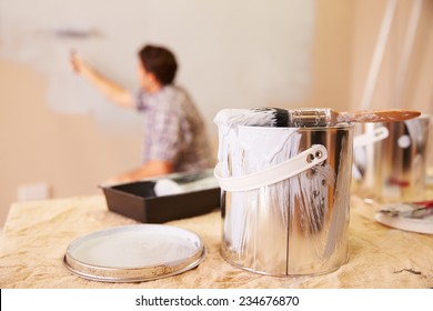 Man Decorating Room Using Paint Roller On Wall - Shutterstock ID 234676870