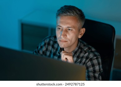 Man Deep In Thought Working Late At Office On Computer, Concentrating, Focused, Determined - Powered by Shutterstock