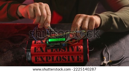 Man defusing bomb at table, closeup