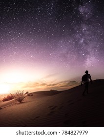 Man in desert with night sky during sunset, Dubai