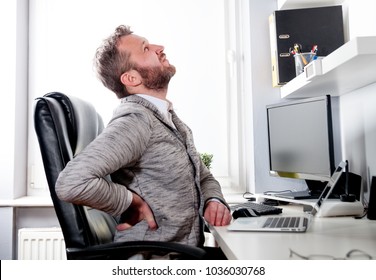 Man in desk office suffering from back pain