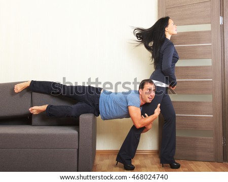 Man desperately clinging to the leg of a woman