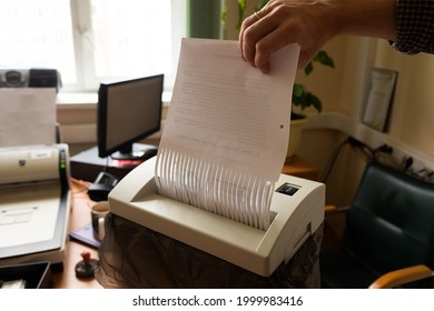 a man destroys paper documents in a shredder. copy space