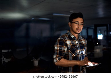 Man, developer and tablet in office at night for software development, coding and code analytics. Male programmer, digital and process script, firewall update and IT for data protection of project