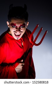 Man In Devil Costume In Halloween Concept