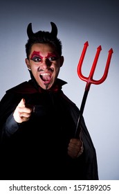 Man In Devil Costume In Halloween Concept