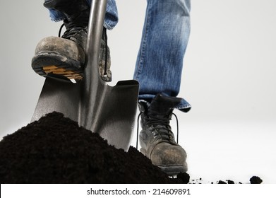 Man Digging With Foot On Shovel Applying Pressure On White Background