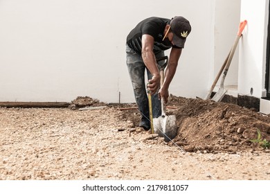 Man Digging A Hole In The Ground With Shovel