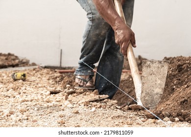 Man Digging A Hole In The Ground With Shovel