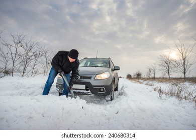 Man Digging Up Stuck In Snow Car